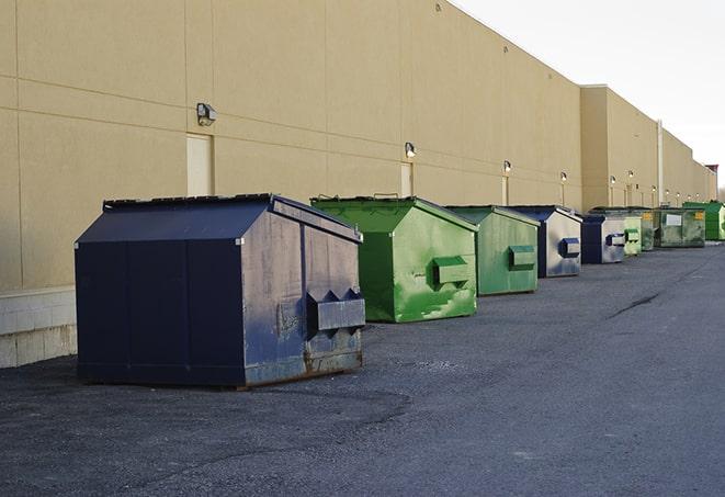 a truck unloading construction waste into a dumpster in Kennesaw